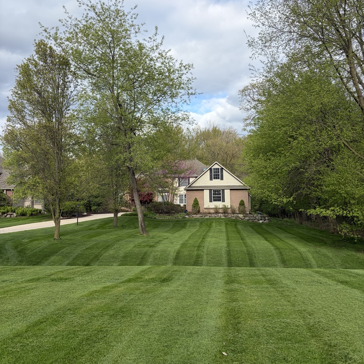 Wide residential lawn with clean mowing stripes